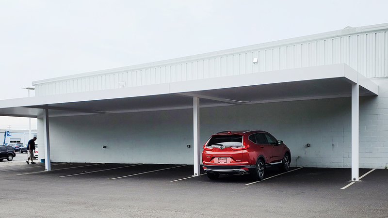 Commercial parking lot covered with aluminum carport