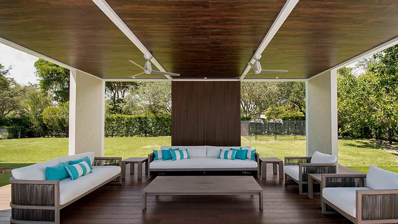 Luxury outdoor space covered with insulated roof pergola in a white frame and custom wood finish roof - The Louvered Pergola in Indiana